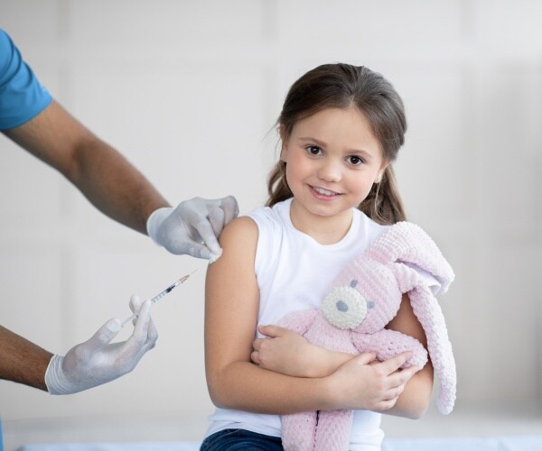 young girl getting a vaccine shot