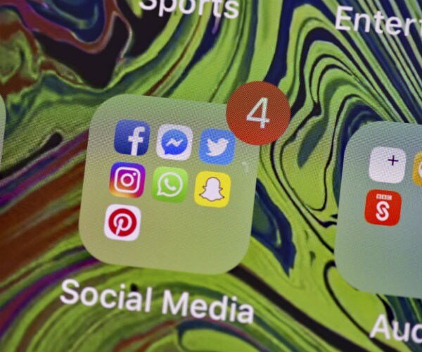 a social media cell phone icon is shown with different logos for facebook, twitter, snapchat, instagram and pintrest