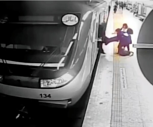 surveilance video image of a person appearing to be dragged from a subway car