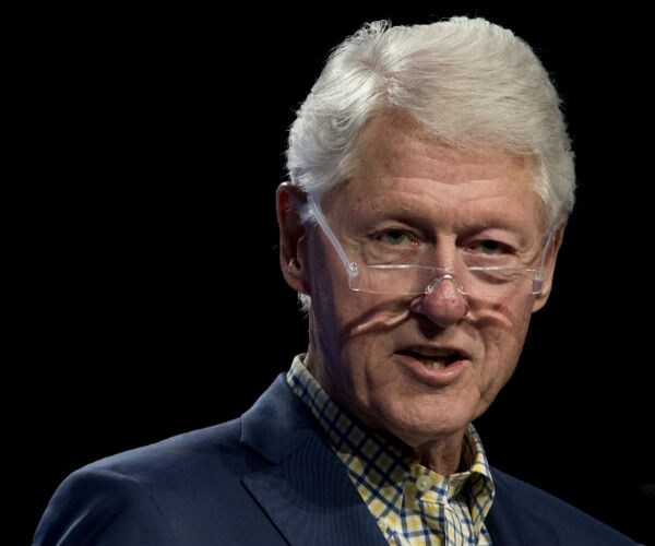 bill clinton is shown with his glasses tipping off his nose