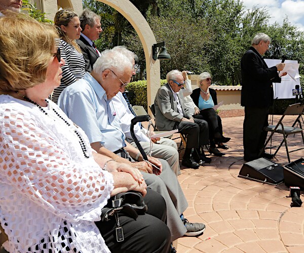 David Mermelstein speaks during a news conference as others look on