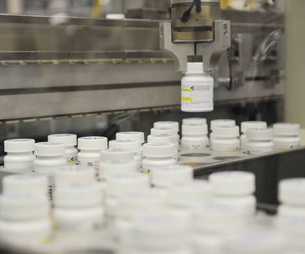 prescription bottles coming off an assembly line