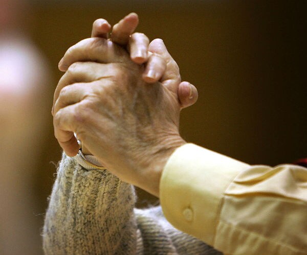 an couple holding hands while dancing
