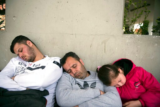 In Greek City, Refugees Wait in Line  to Get Arrested