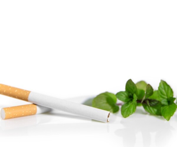 two cigarettes, with menthol leaves