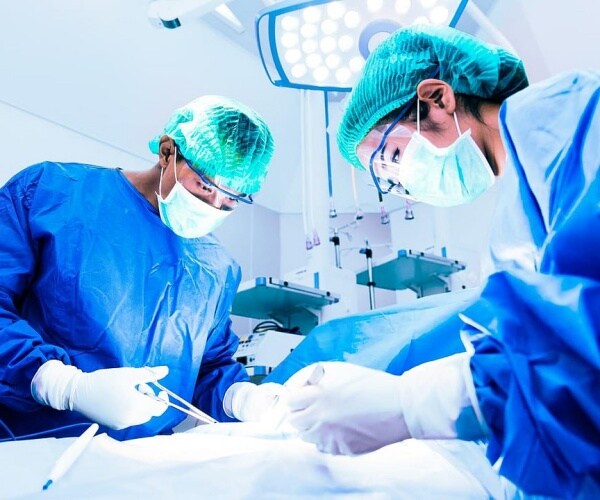 Doctors performing surgery on a patient