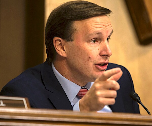 Chris Murphy gestures as he speaks during a senate committee hearing