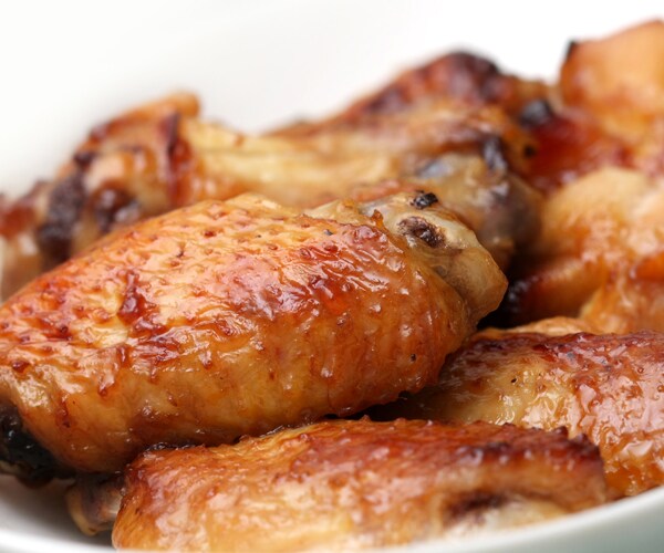 cooked chicken wings piled up on a plate