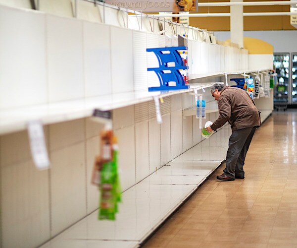 empty store shelves where racks of toilet paper were getting snatched up during the global coronavirus pandemic