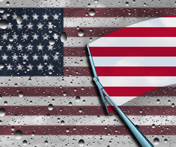 wiper clearing the gray dark wet clouds from american flag