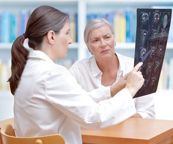 a doctor and patient looking at a brain scan