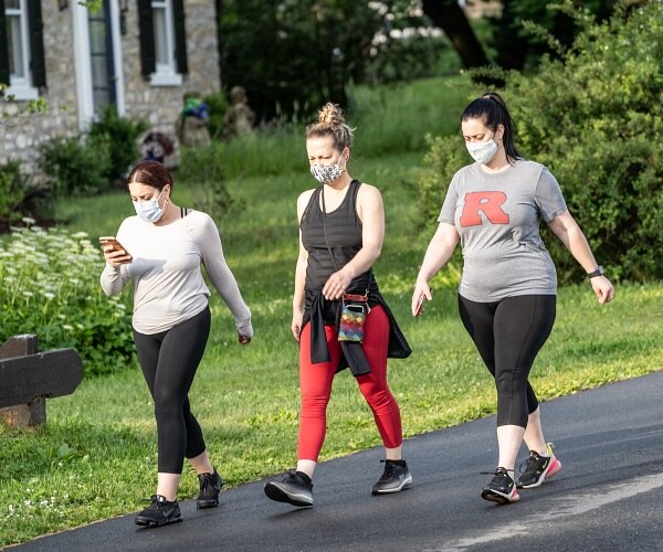 three women walking down the street
