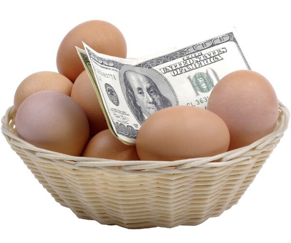 a basket of eggs with hundred dollar bills mixed in with them
