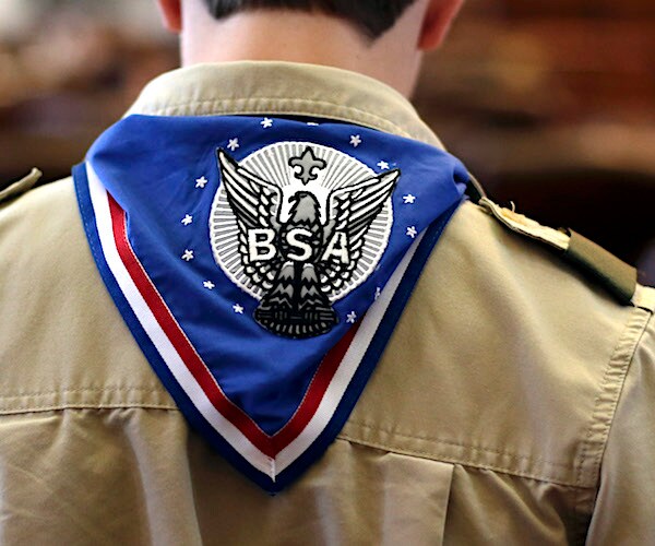 the back of a boy scout with a scarf showing the boy scouts of america wings and logo