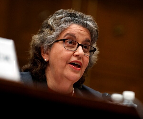 ellen weintraub sits behind table