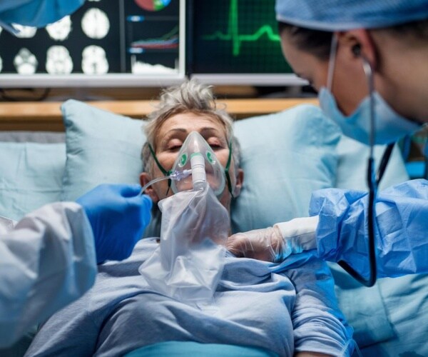 woman in hospital receiving care and oxygen