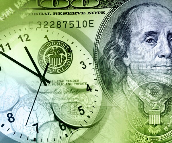 clock face superimposed over benjamin franklin one hundred dollar bill