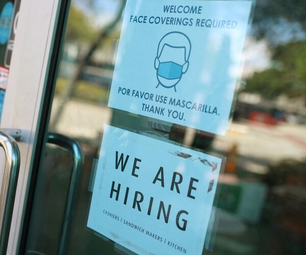 we are hiring sign posted in store window