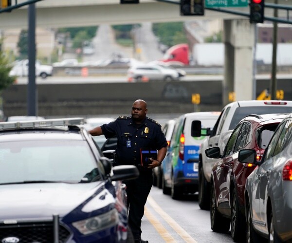  police officer arrives at a condominium building