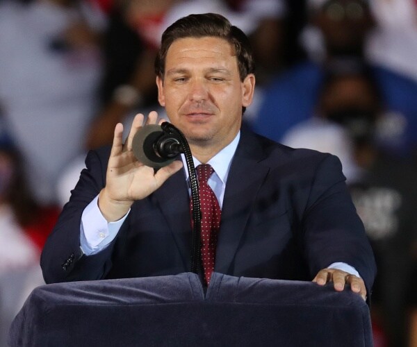 ron desantis speaks from behind podium