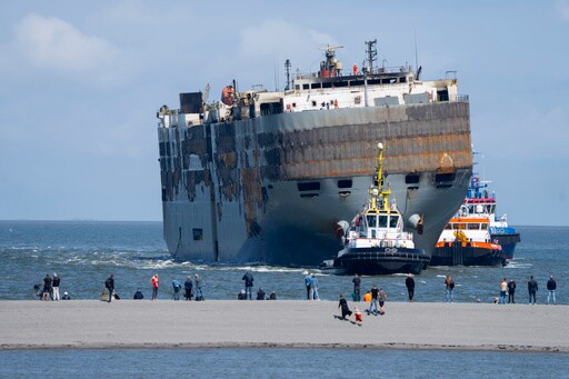 A Car-carrying Ship That Burned for a Week on the North Sea Is Towed to a Dutch Port for Salvaging