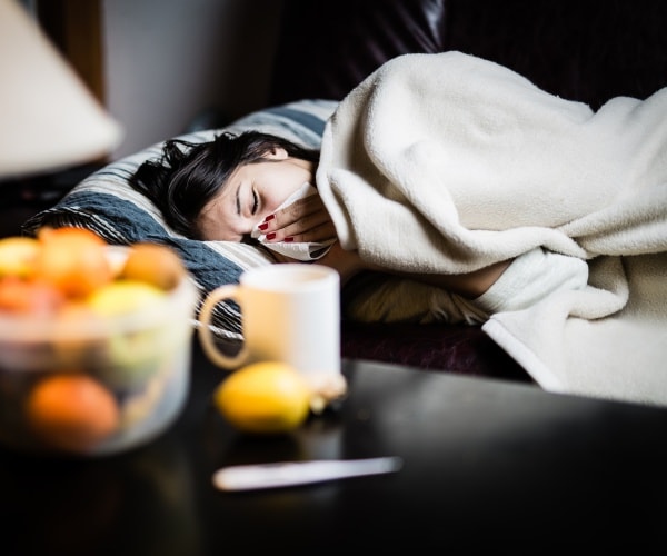 woman in bed with bad case of flu