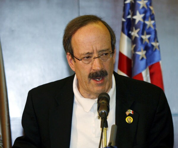 Rep. Eliot Engel speaks during a new conference with the U.S. flag in the background.