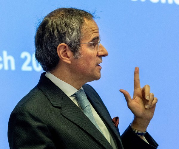 man pointing while he speaks