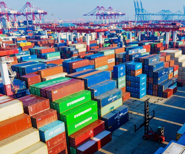 shipping containers are stacked up in the chinese port of qingdao