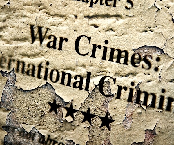 Close up of scrolls that read war crimes international