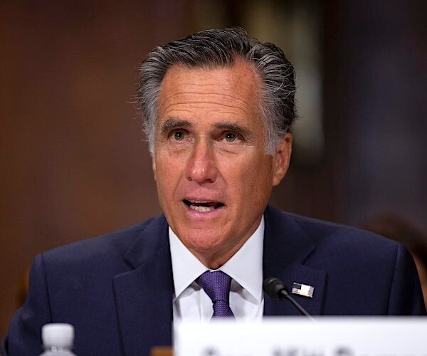 mitt romney speaks during a senate hearing
