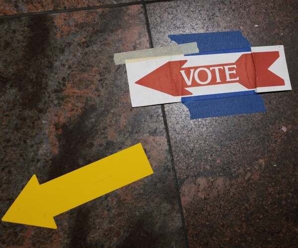 Signs taped to the floor direct voters to the polls
