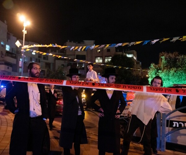 people standing behind police tape