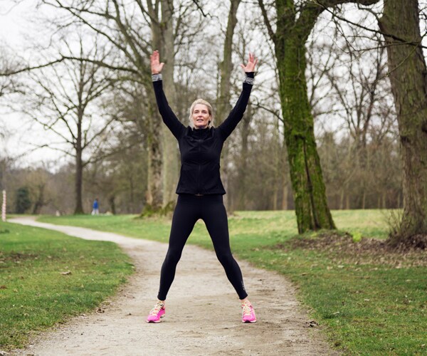 A woman doing jumping jacks