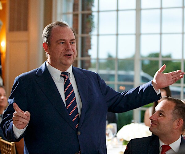 newsmax ceo christopher ruddy is shown in over jacket, blue button-down shirt