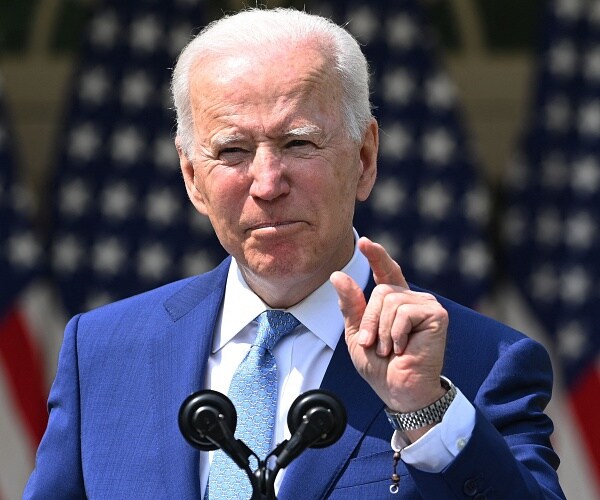 joe biden speaks from podium in rose garden