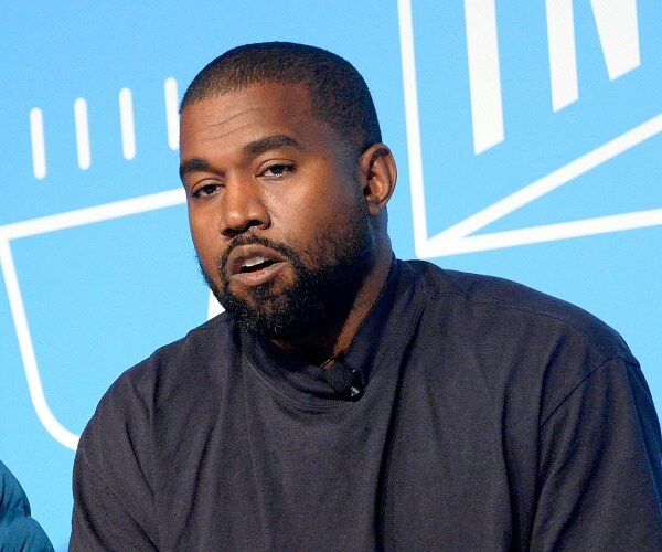 kanye west sits onstage