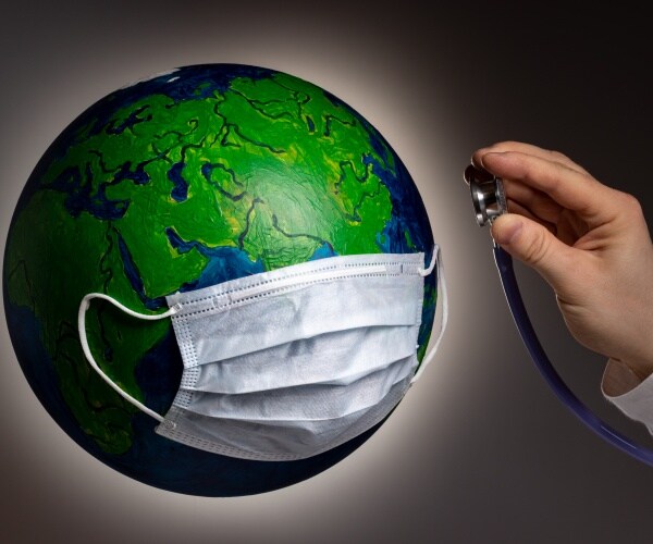 globe with a surgical mask and hand holding a stethoscope to the world