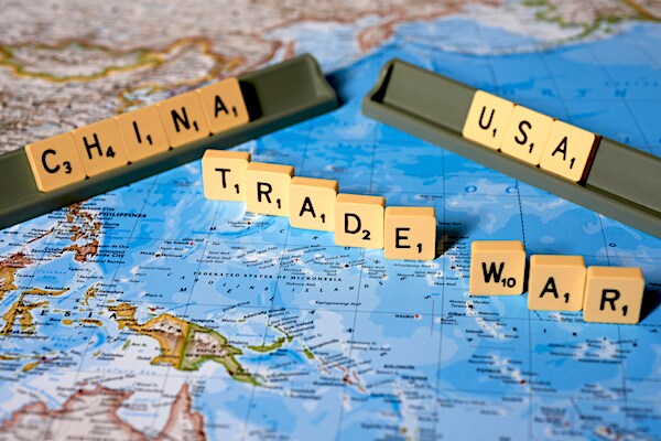 a map of china with scrabble tiles spelling out china usa trade war