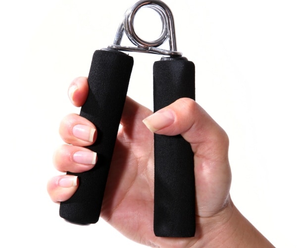 woman squeezing exercise tool for grip strength