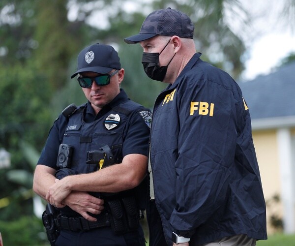 police officer talks to fbi agent in street