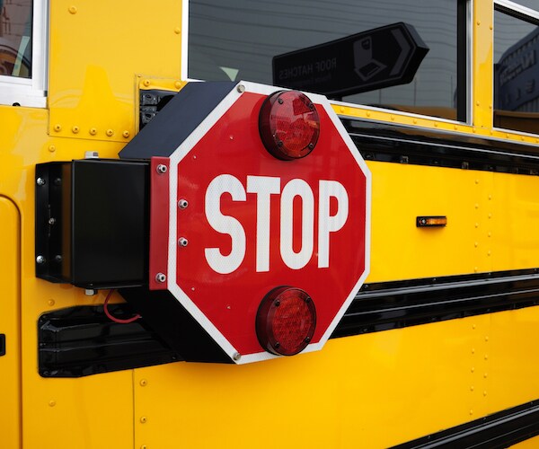 side view of a school bus and its the stop signal.