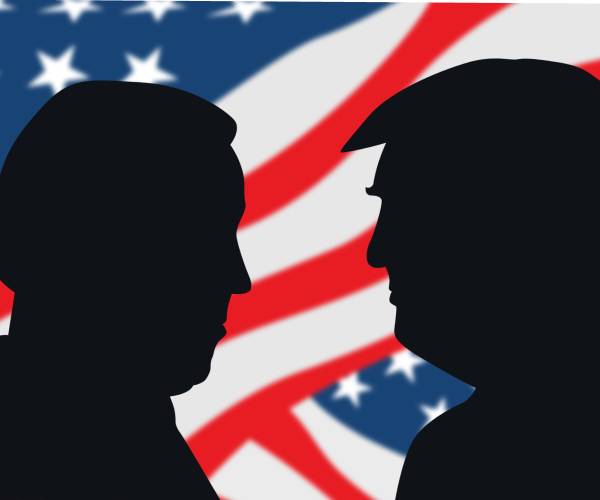 cutouts of biden and trump in front of american flags