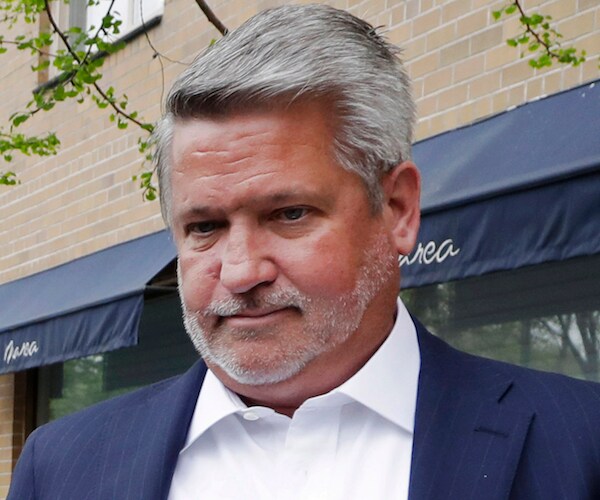 white house communications director bill shine looks down as he awaits a reporter's question