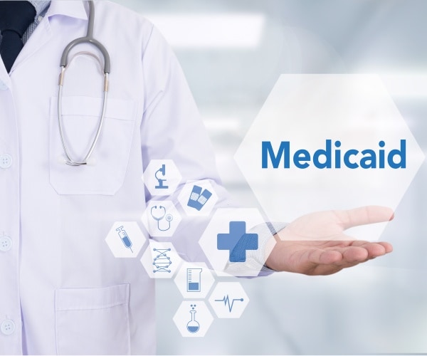 illustration of doctor holding the word 'Medicaid'