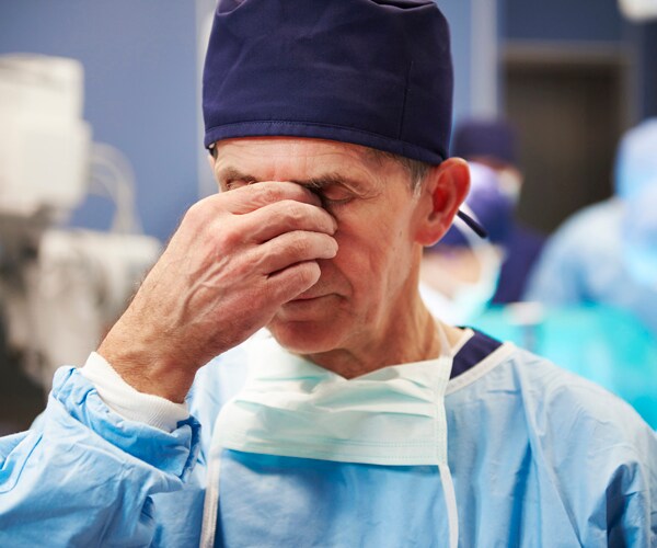 a doctor showing signs of fatigue