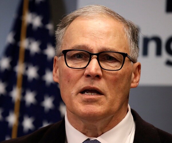 jay inslee speaks into mic