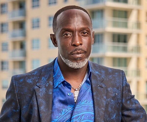 michael k williams stands on balcony