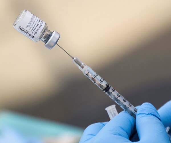 person prepares vaccine