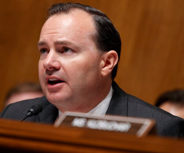mike lee listens during a congressional hearing